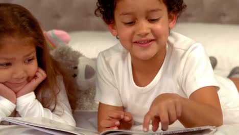 Hispanic-children-reading-a-book-together