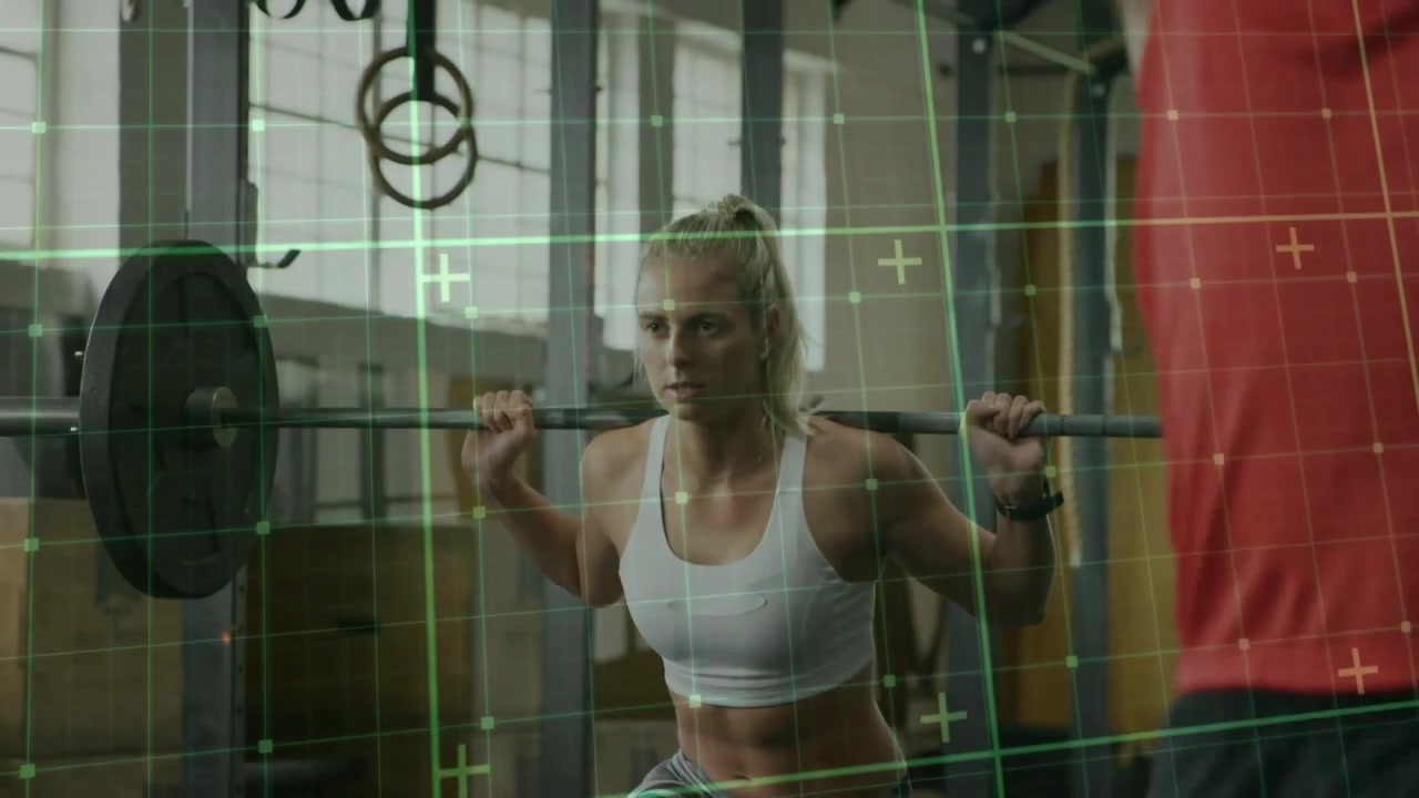Woman lifter unracking barbell doing squats for training coach aiding green grid shifting on lifter
