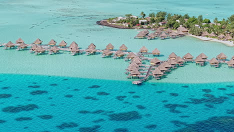 bora bora island, french polynesia. drone shot of overwater villas of luxury resort and lagoon