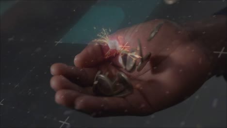 animación de chispas sobre monedas que caen en una mano
