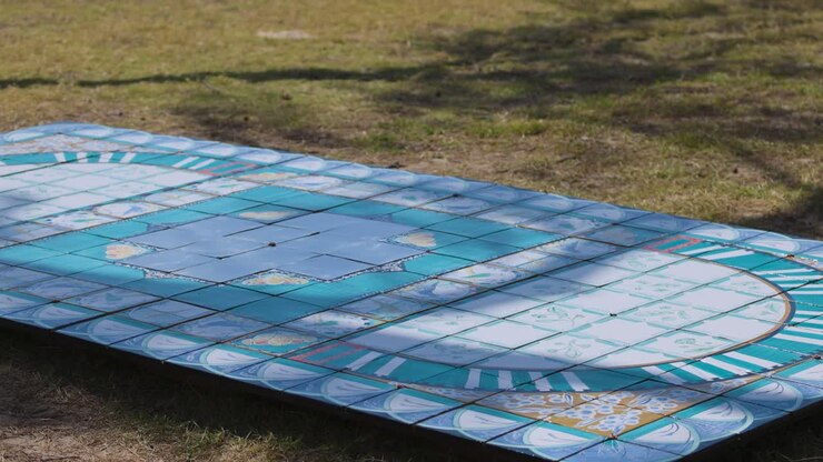Colorful abstract tile art installation on grass