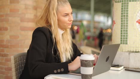 freelancer woman working with laptop in cafe