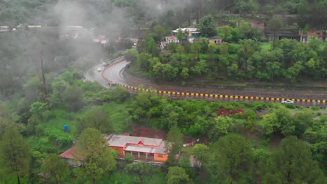 drone flying forward towards four lane e75 expressway on misty foggy day