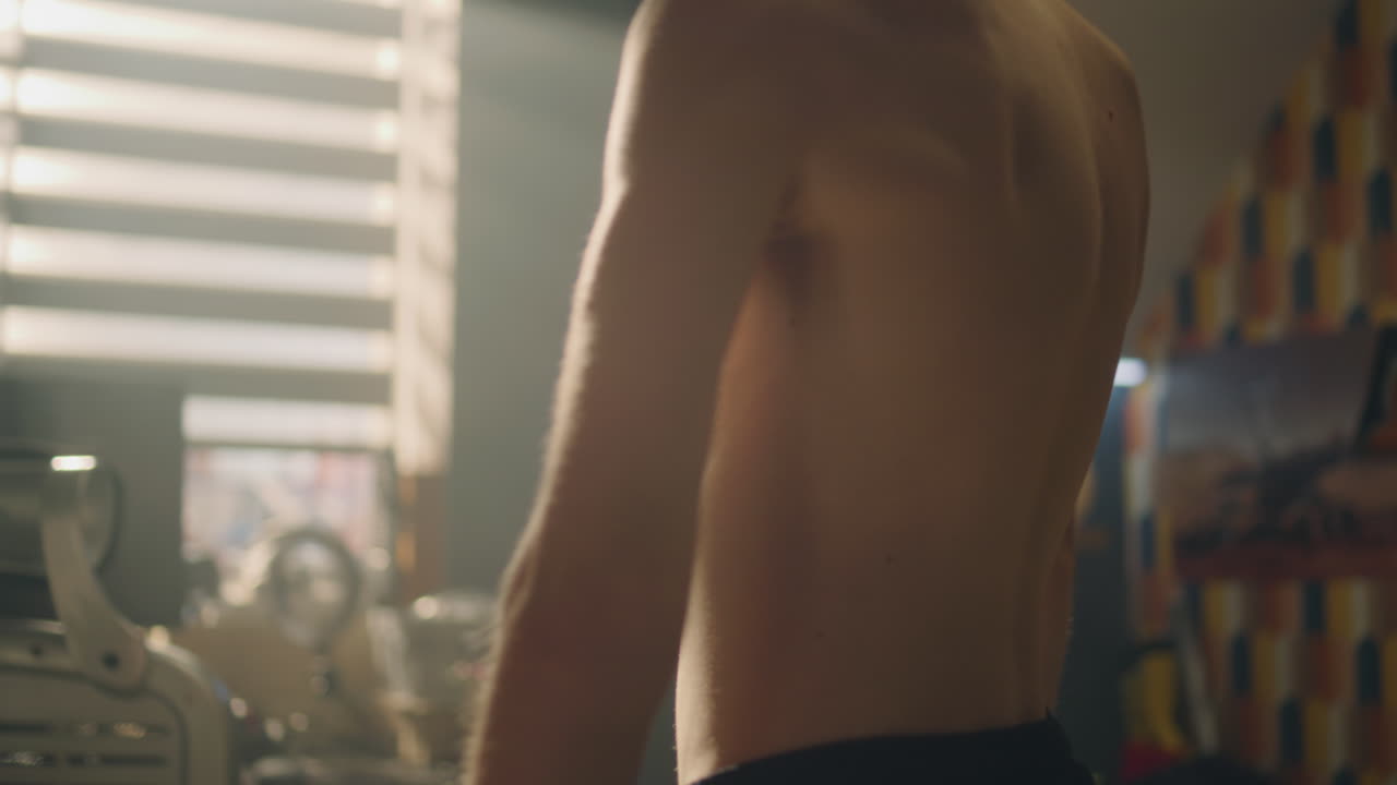 Teenage boy back view, showing thin build