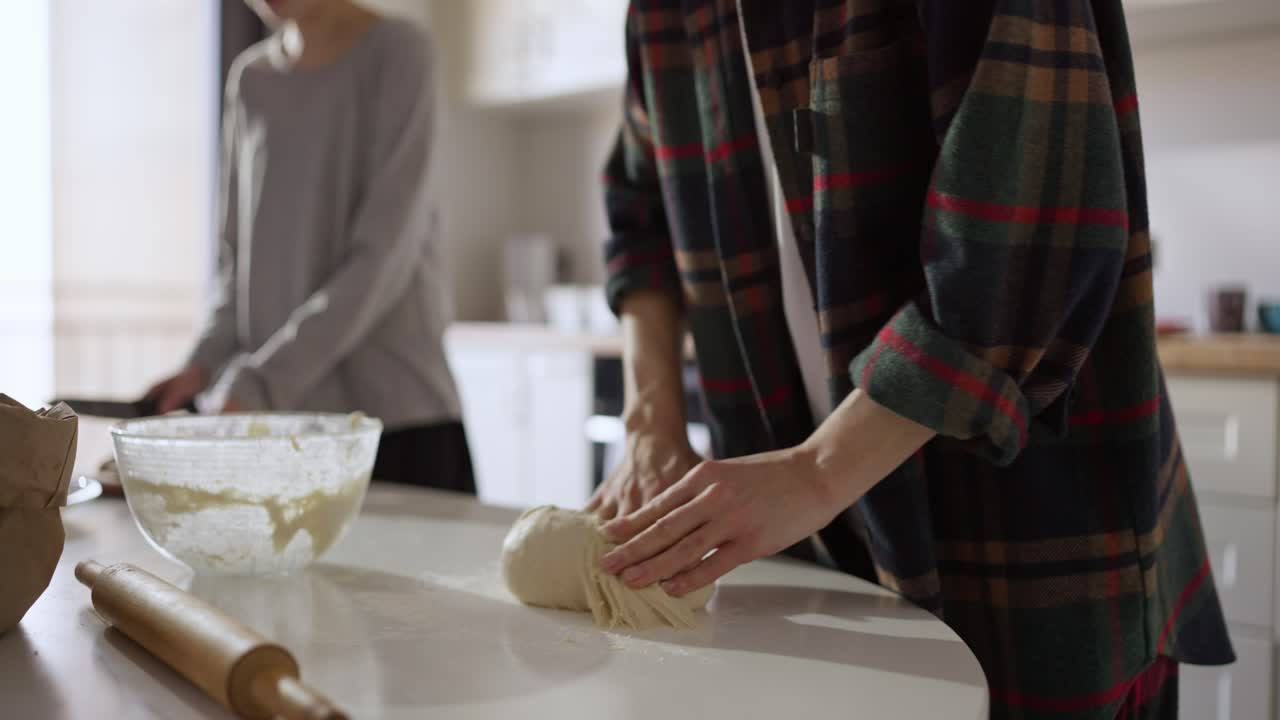 People kneading dough in the kitchen