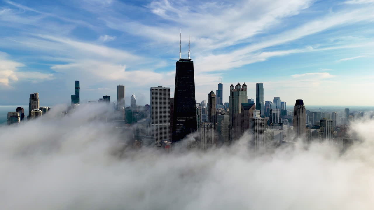 Panoramic drone shot orbiting the misty skyline of Chicago, sunny day in USA