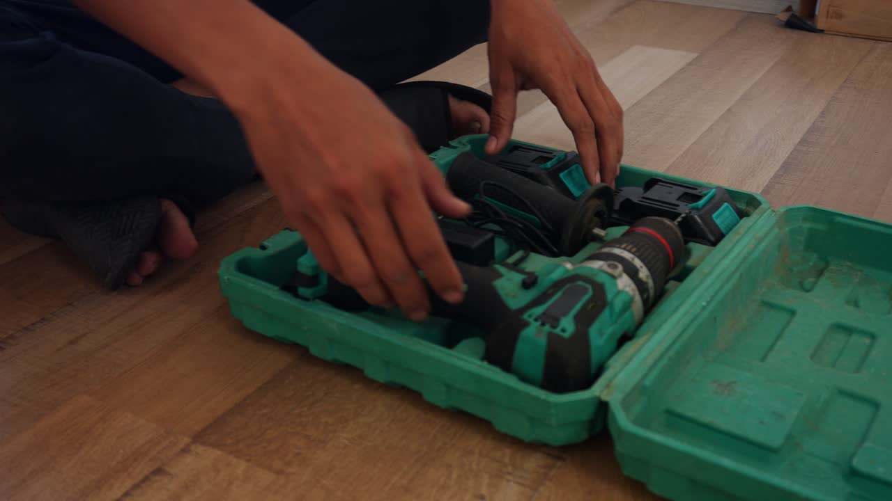 Confident handyman using power drill for home renovation project