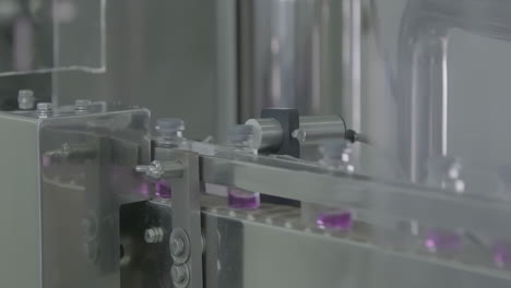 sterile conveyor belt rows of glass vials antibiotics move along a production line in a pharmaceutical facility. clean, sterile, and efficient manufacturing process.