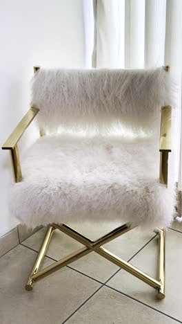 elegant gold chair with white plush. vertical shot