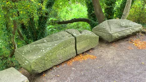 Forest-and-green-trees-with-a-big-old-rock-that-was-reconstructed-in-1920-in-Chippenham-England,-4K-shot