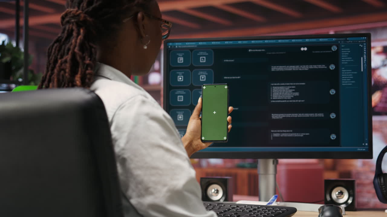 Woman uses mockup phone, doing videocall in front of PC screen with AI chatbot