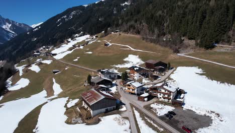 austrian mountain huts high up half covered in snow on a lovely sunny day