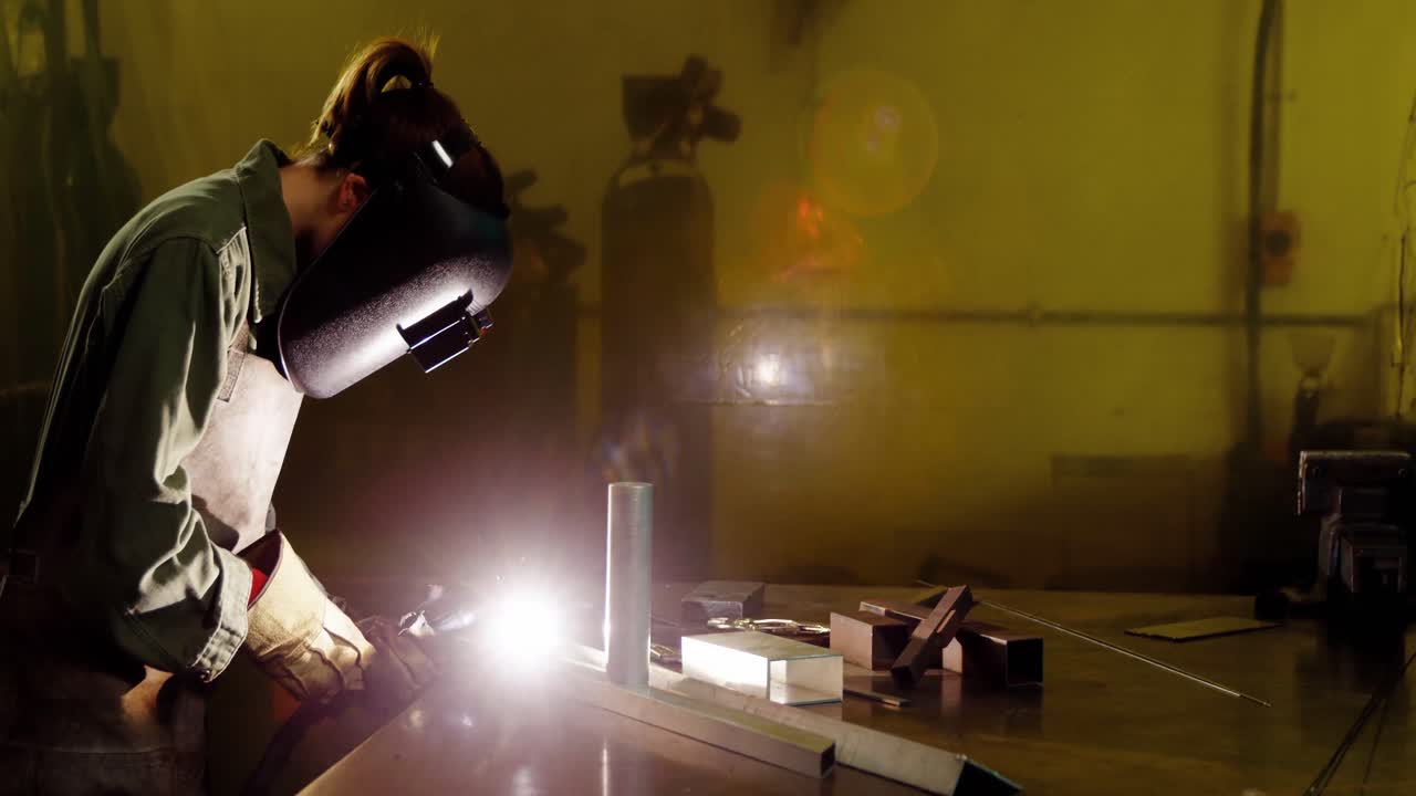 Female welder welding a metal