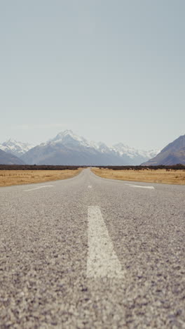 empty road leading to majestic mountains