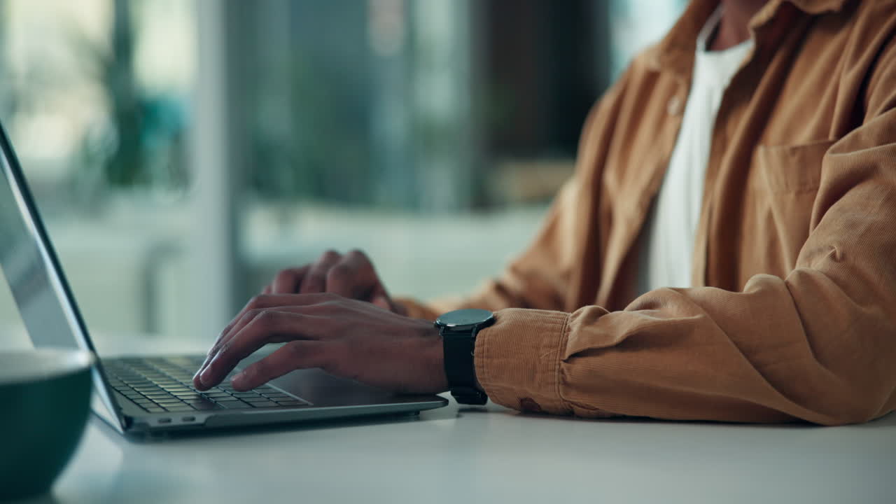 Man typing on a laptop