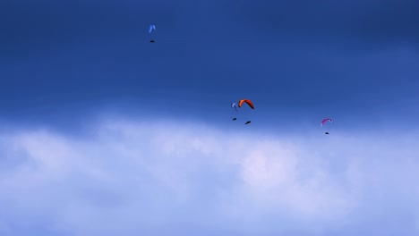 group of paragliders against moody sky