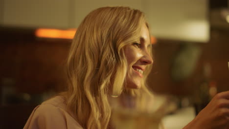 portrait of smiling woman holding glass of wine