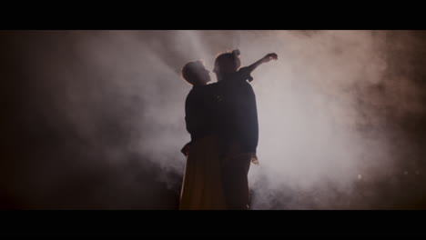 couple dancing in smoky night
