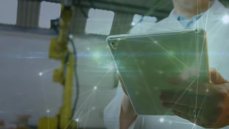 Animation-of-hands-of-caucasian-man-using-tablet-in-computer-laboratory