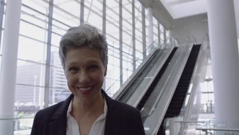 businesswoman looking upwards in the lobby at office 4k