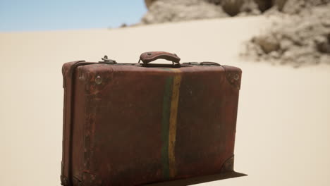 vintage suitcase abandoned in the desert