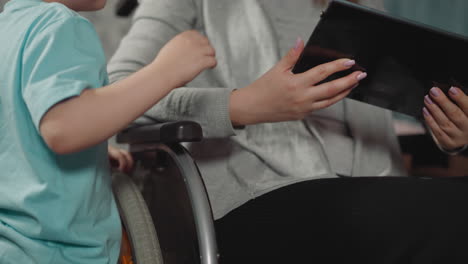 curious toddler watches mommy checking mail on modern tablet