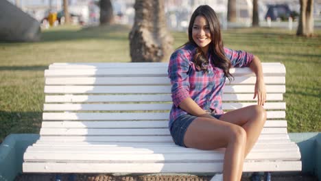 Girl-Relaxing-On-Bench-In-Park