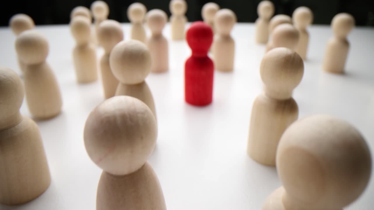 Wooden figurines representing leadership and individuality