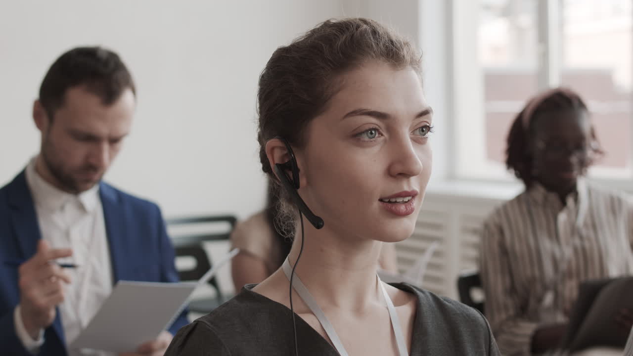 Businesswoman in Headset Looking and Smiling
