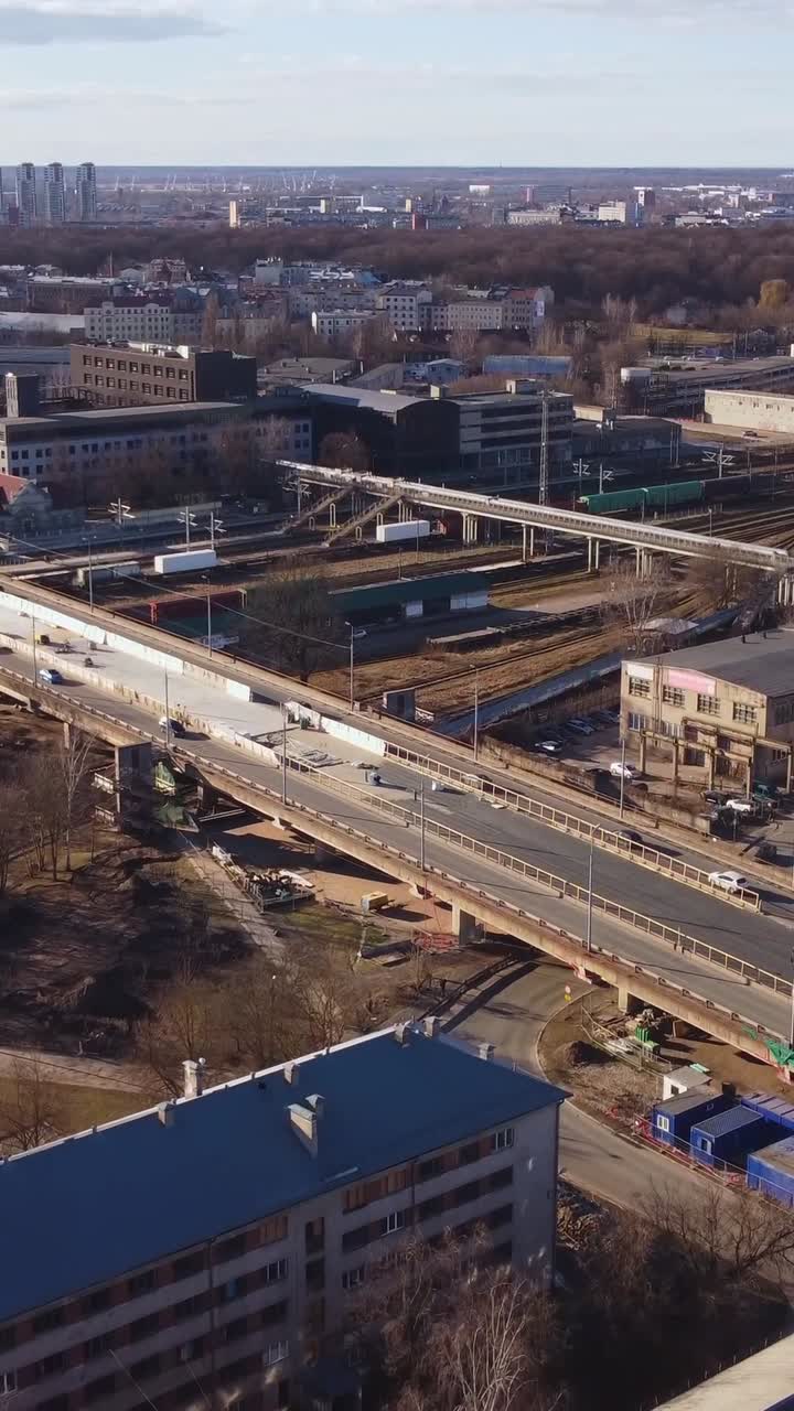 Vertical drone view of a bridge construction in city. Roadwork in urban area. Road maintenance at standstill.