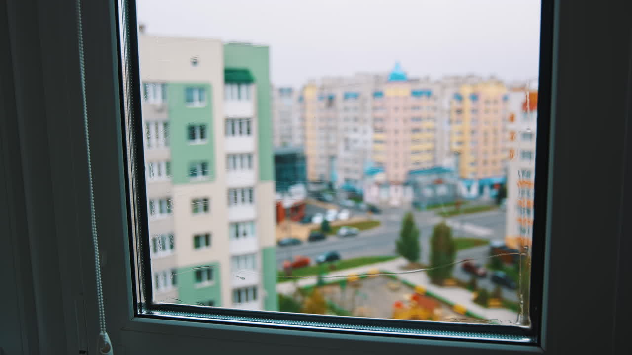 Polishes windows with sponge. View through the window cleaning washing windows by special mop