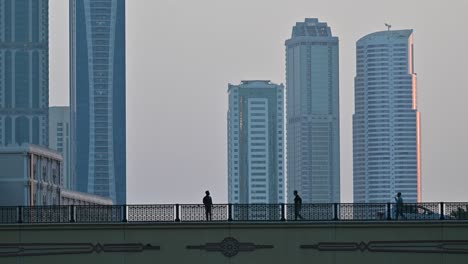 4k: people on the bridge, city traffic and modern residential towers in the background