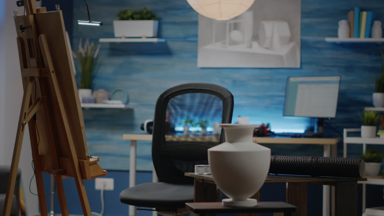 Empty art studio room filled with drawings and white vase