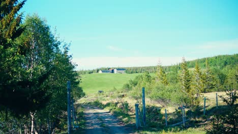 rural scene of a path overlooking architecture on the sunny green hills