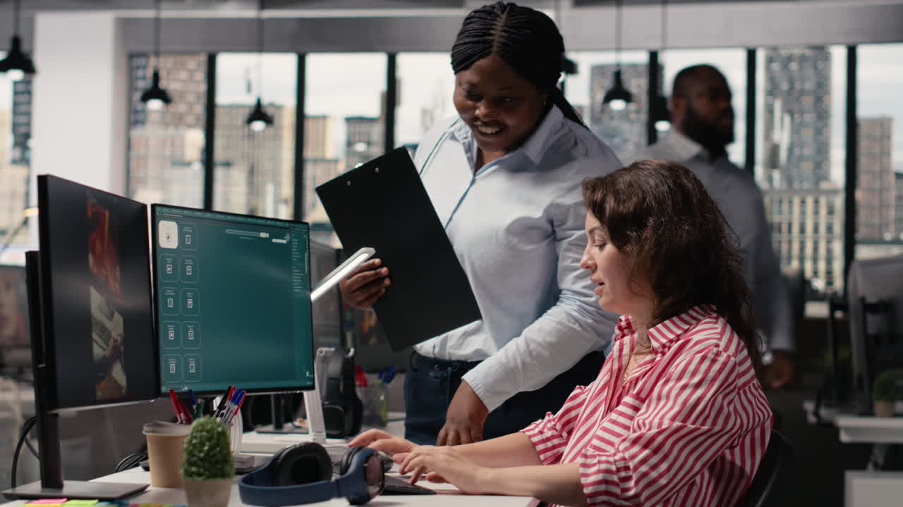 Two Businesswomen Collaborating on Computer Project in Modern Office