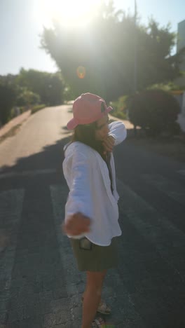 young woman enjoying a sunny day on the street