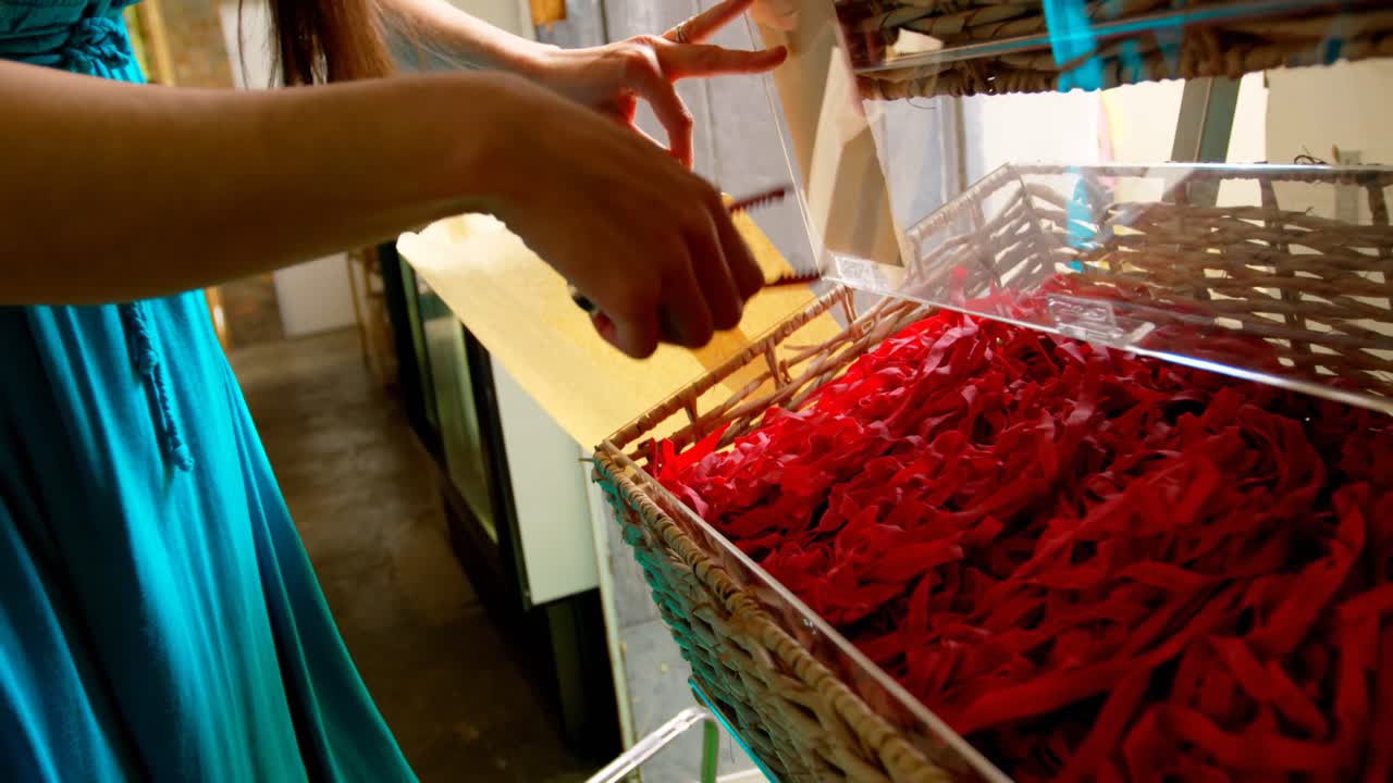 Close-up of woman packing snacks in supermarket 4k