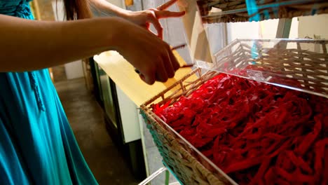 Close-up-of-woman-packing-snacks-in-supermarket-4k