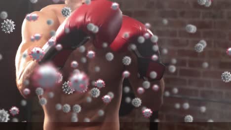 Animation-of-virus-cells-floating-over-caucasian-man-boxing