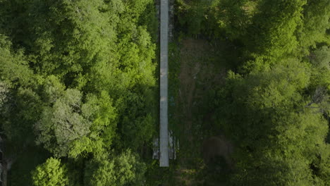 fly over abandoned ski jumps in lush forest mountains of bakuriani in georgia