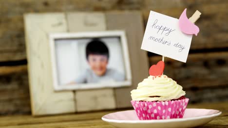 close-up of delicious cupcake with happy mothers day label