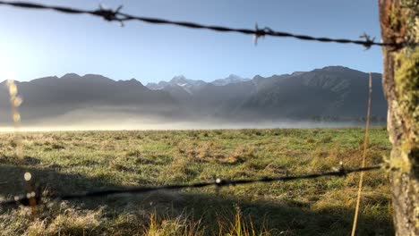 Snowy-peaks-of-Mt-Cook-and-Mt-Tasman,-New-Zealand-with-barbwire-fence-in-foreground