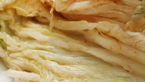 close-up of texture fermented spicy cabbage kimchi with in can. preservation of vegetables in glass jars. fermentation preserved kimchi cabbage with spices macro. asian cuisine. high quality 4k footage