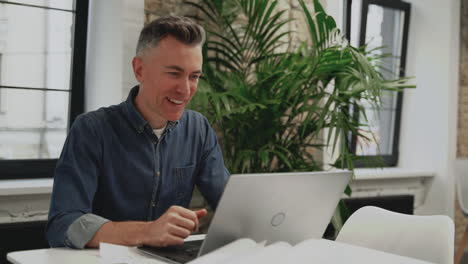 mature male having a video call. copy space. businessman teleworking with laptop.