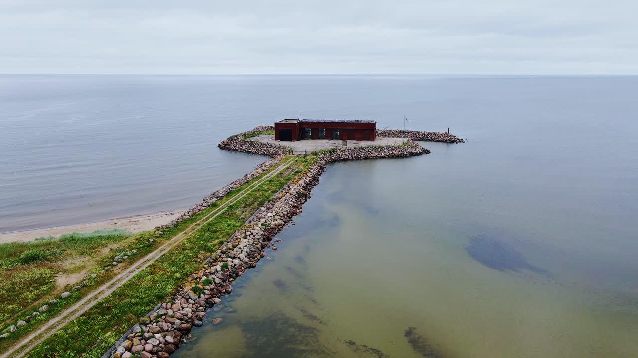 Aerial view of pier architecture blending with natural tones of land, Latvia