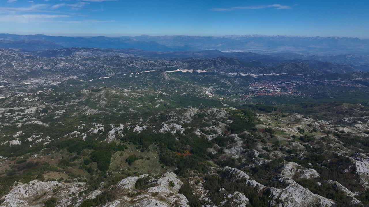 Expansive view of Lovćen’s rugged terrain under a bright blue sky in Montenegro
