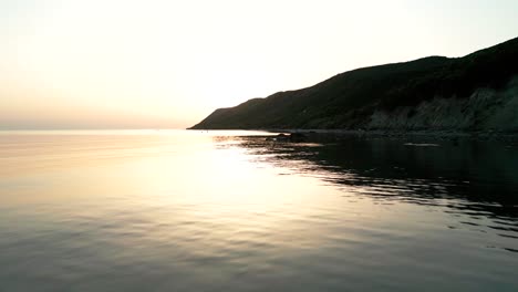 sunset behind the mountains over the adriatic sea, aerial view from a drone