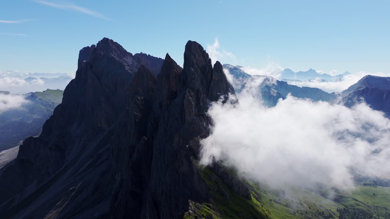 Majestic alpine cliffs pierce drifting clouds over Seceda in the Dolomites