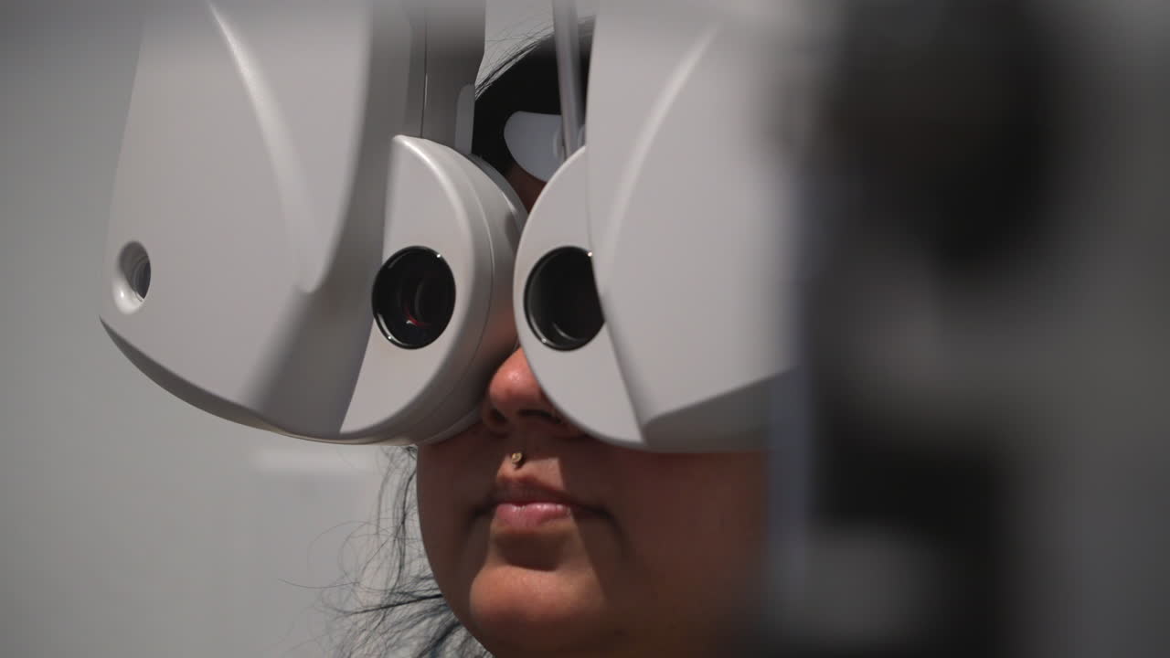 Close-up of an optometrist testing prescription lenses with advanced optical equipment