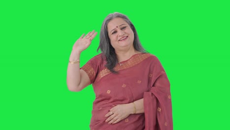 Happy-Indian-old-woman-waving-and-saying-Hello-Green-screen